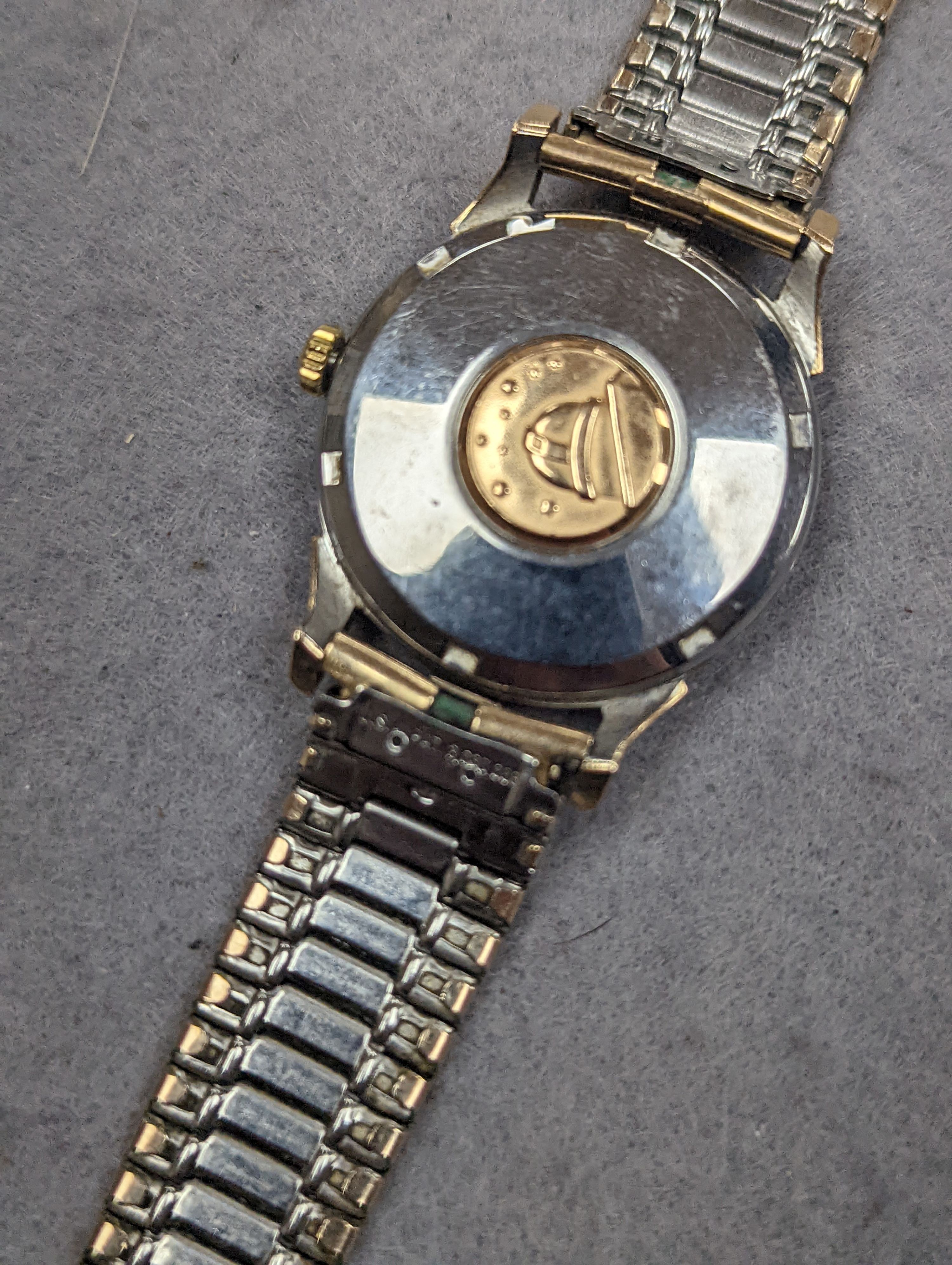 A gentleman's steel and gold plated Omega Automatic Constellation black dial wrist watch, on associated bracelet, case diameter 34mm (winding crown a.f.).